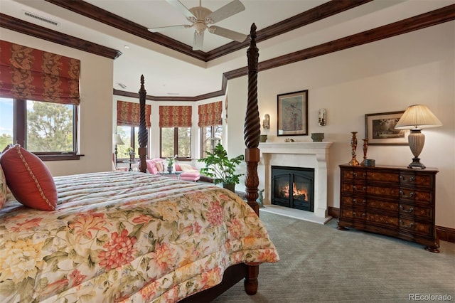 carpeted bedroom featuring ceiling fan and ornamental molding