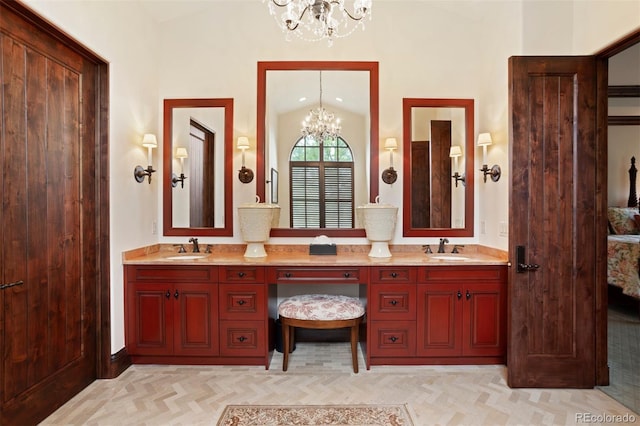 bathroom with vanity, lofted ceiling, and a notable chandelier