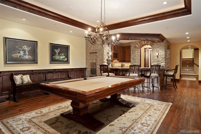 recreation room featuring an inviting chandelier, dark hardwood / wood-style flooring, billiards, a tray ceiling, and ornamental molding