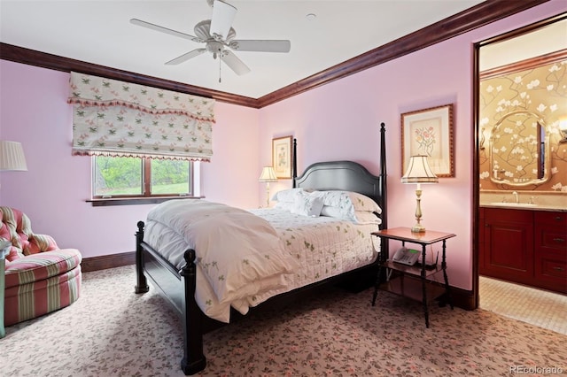 carpeted bedroom with ceiling fan, sink, ensuite bathroom, and ornamental molding