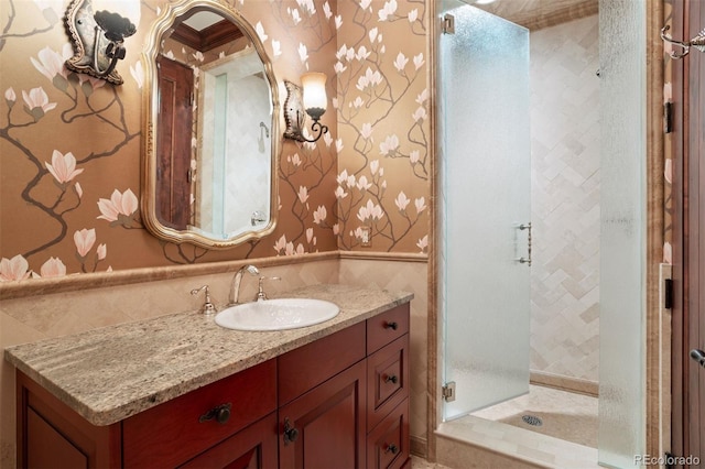 bathroom featuring vanity and a shower with shower door