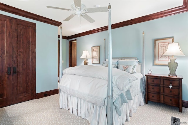 carpeted bedroom with ceiling fan and crown molding