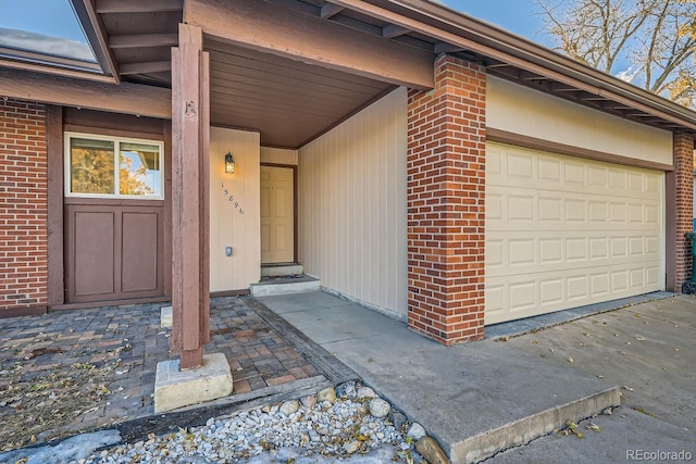 view of exterior entry with a garage