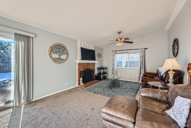 carpeted living room with a fireplace, vaulted ceiling, and ceiling fan