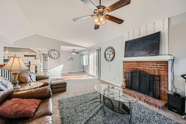 carpeted living room featuring ceiling fan, a fireplace, and lofted ceiling