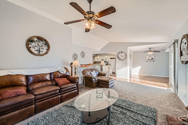 carpeted living room featuring ceiling fan and lofted ceiling