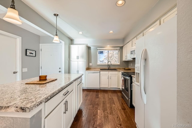 kitchen featuring white appliances, white cabinetry, hanging light fixtures, and sink