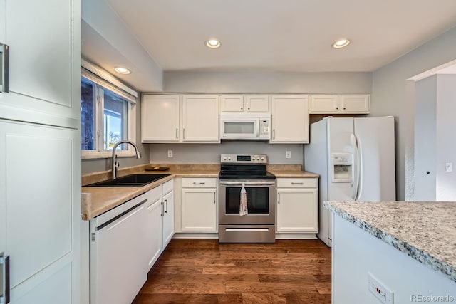 kitchen featuring white cabinetry, sink, appliances with stainless steel finishes, and dark hardwood / wood-style floors