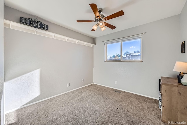 unfurnished room featuring carpet and ceiling fan