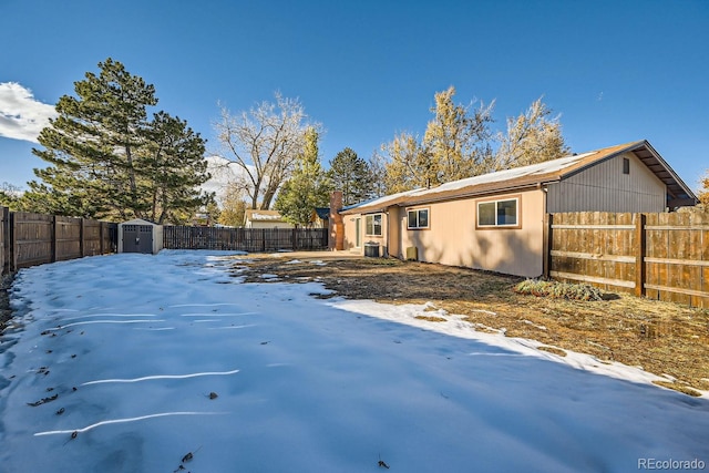 view of snowy exterior with a storage shed