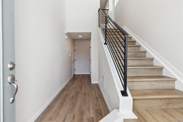 stairway featuring wood-type flooring