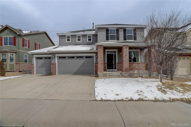 view of front facade featuring concrete driveway, brick siding, and an attached garage