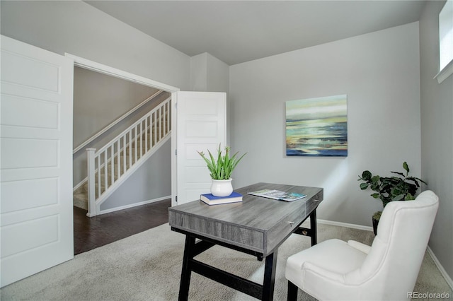 carpeted home office with baseboards