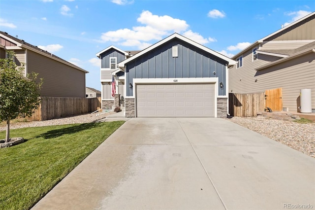 view of front of property featuring a garage and a front lawn