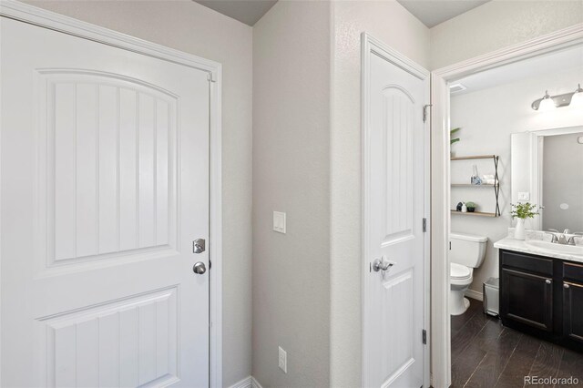 bathroom featuring vanity, toilet, and wood-type flooring