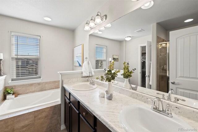 bathroom with plus walk in shower and vanity