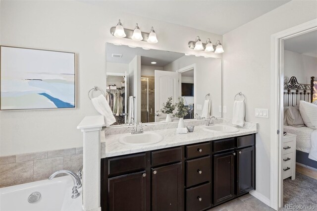 bathroom featuring vanity and a tub