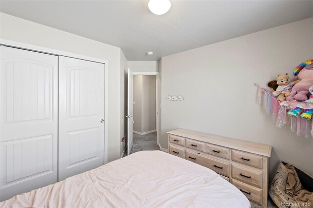 carpeted bedroom with a closet