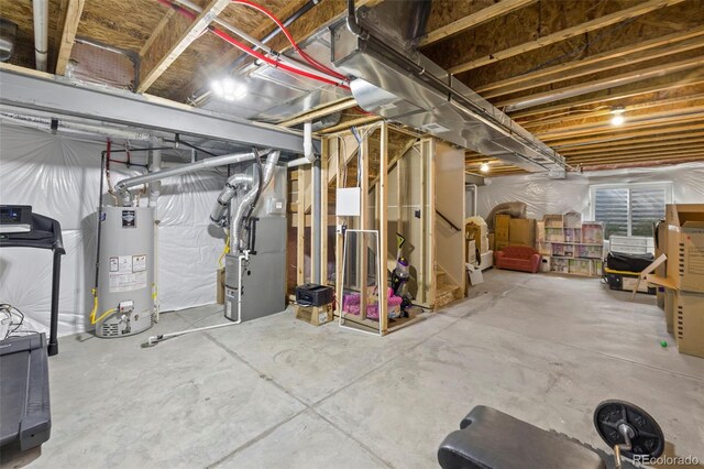 basement featuring heating unit and water heater