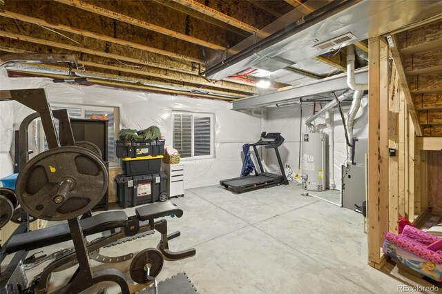 workout room featuring gas water heater