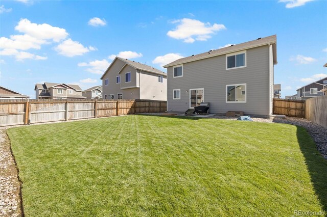 rear view of house featuring a lawn