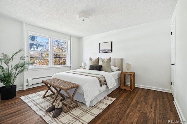 bedroom featuring baseboard heating, dark hardwood / wood-style flooring, and a textured ceiling