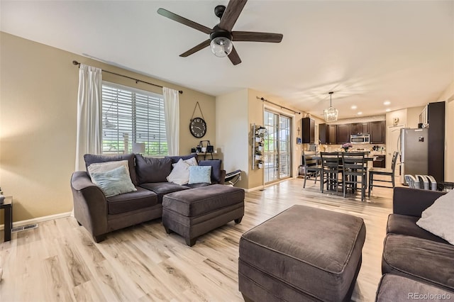 26072 E Fremont Pl, Aurora, CO 80016 - living area with ceiling fan, light wood finished floors, plenty of natural light, and recessed lighting