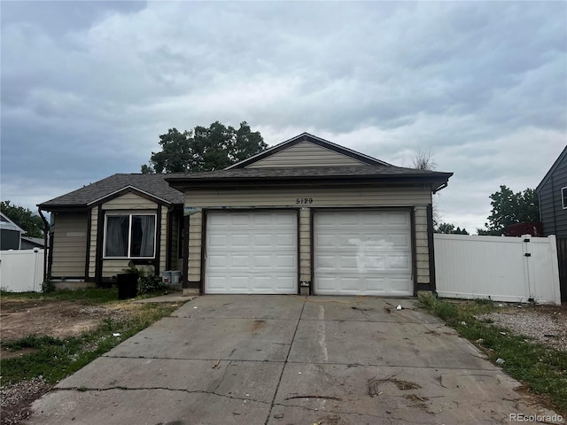 5129 Chandler Way, Denver, CO 80239 - ranch-style house featuring concrete driveway and a garage