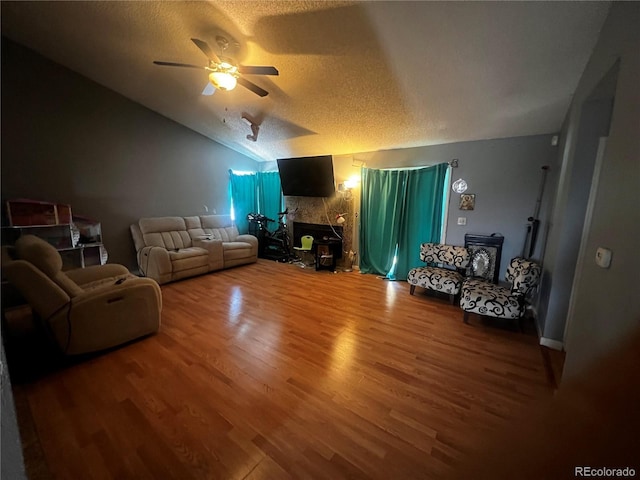 5129 Chandler Way, Denver, CO 80239 - living area with wood finished floors, a textured ceiling, a fireplace, lofted ceiling, and a ceiling fan