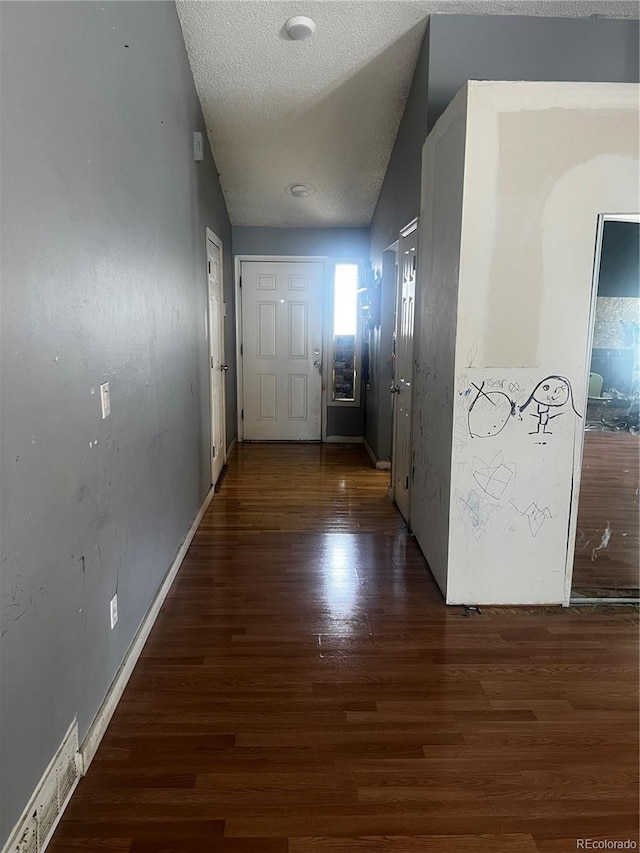 5129 Chandler Way, Denver, CO 80239 - hallway with wood finished floors, a textured ceiling, and baseboards