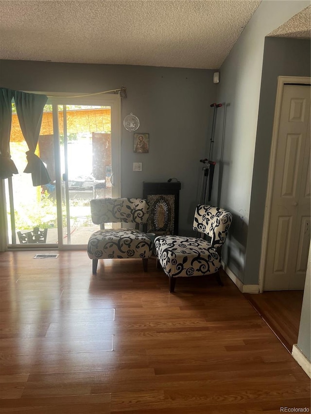 5129 Chandler Way, Denver, CO 80239 - living area with wood finished floors and a textured ceiling