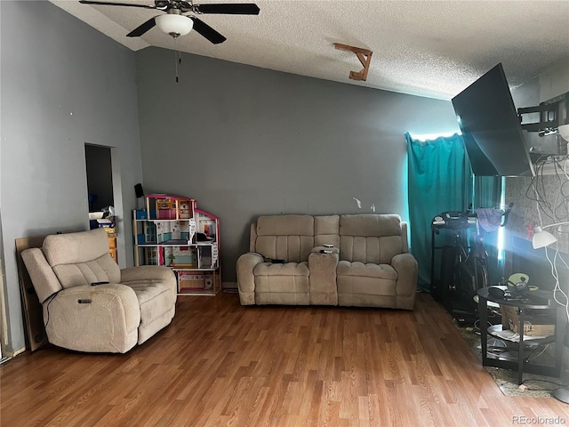 5129 Chandler Way, Denver, CO 80239 - living room with a ceiling fan, wood finished floors, vaulted ceiling, and a textured ceiling