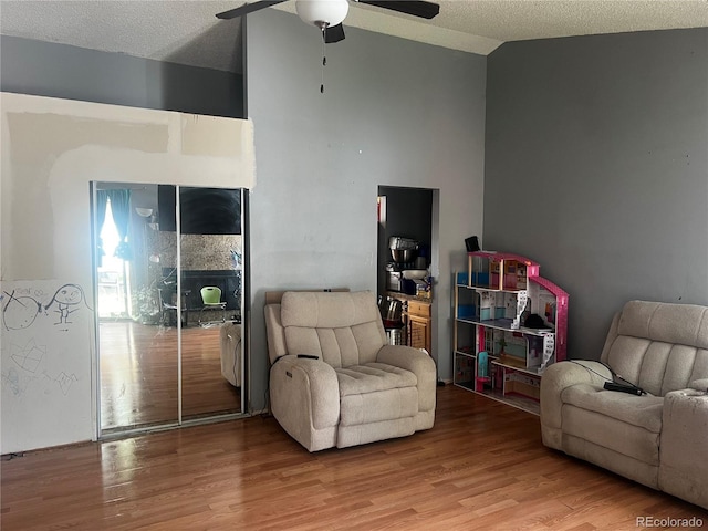 5129 Chandler Way, Denver, CO 80239 - living area featuring ceiling fan, wood finished floors, and a textured ceiling
