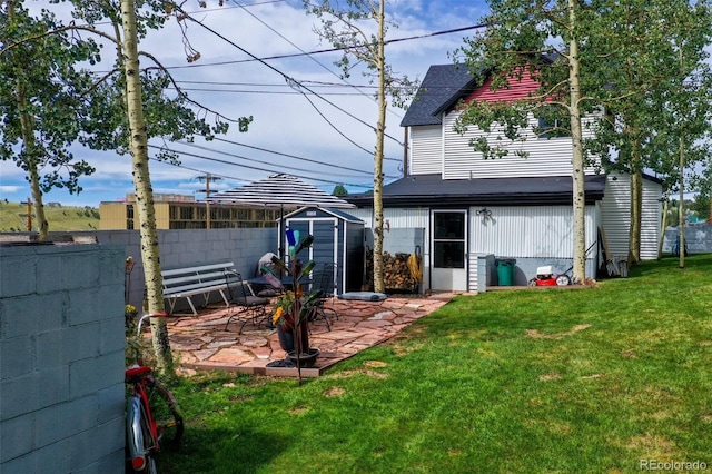 view of yard featuring a storage shed and a patio