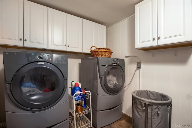 washroom featuring cabinets, independent washer and dryer, and dark hardwood / wood-style flooring