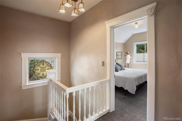 hall with carpet flooring and vaulted ceiling