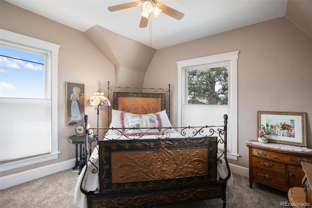 carpeted bedroom with ceiling fan, lofted ceiling, and multiple windows