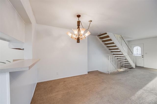 unfurnished living room featuring carpet floors and a notable chandelier