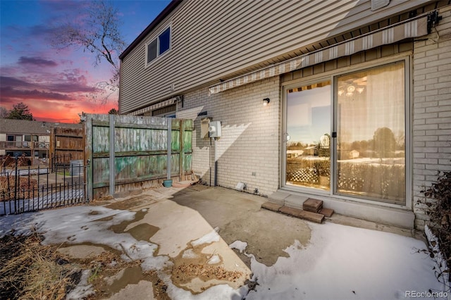 view of patio terrace at dusk