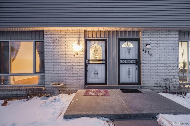 view of snow covered property entrance