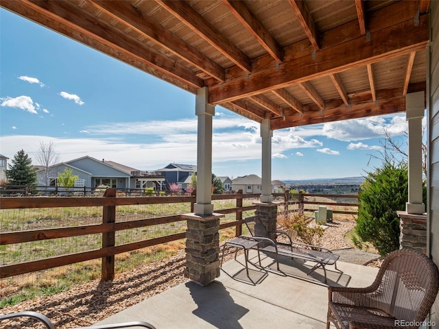 view of patio featuring a residential view and fence