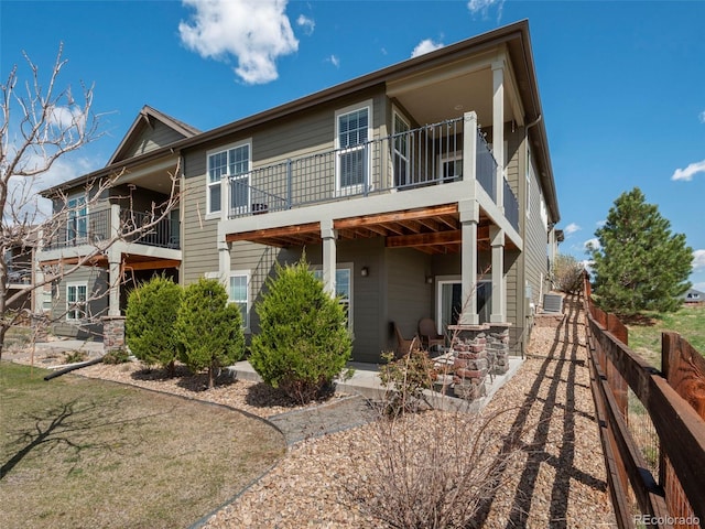 back of house featuring fence and central AC unit