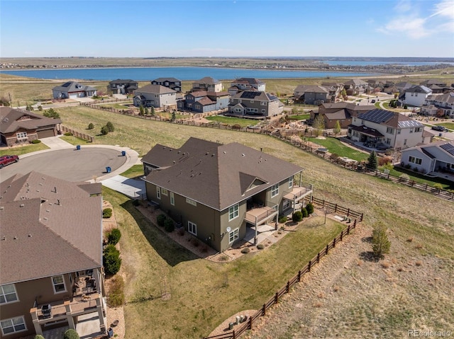 aerial view of residential area featuring a large body of water