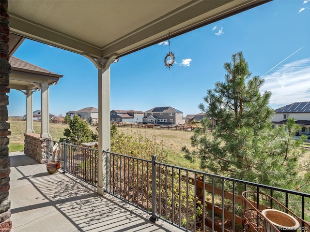 view of patio / terrace with a residential view and a balcony