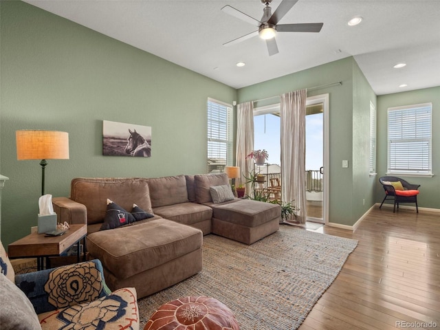 living room featuring a ceiling fan, healthy amount of natural light, wood-type flooring, baseboards, and recessed lighting