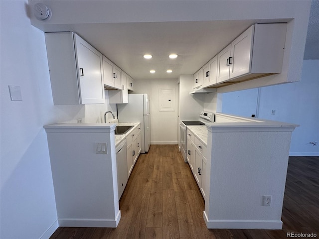 kitchen with white appliances, dark wood-type flooring, white cabinetry, recessed lighting, and light countertops