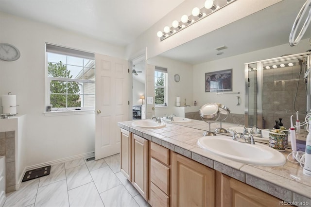 bathroom with double vanity, a sink, and a shower stall