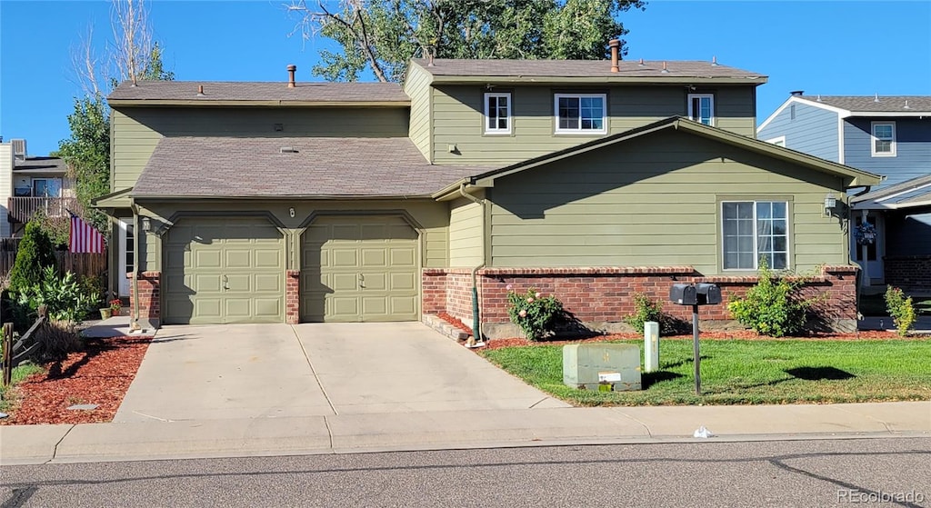 view of front of house with a front lawn and a garage