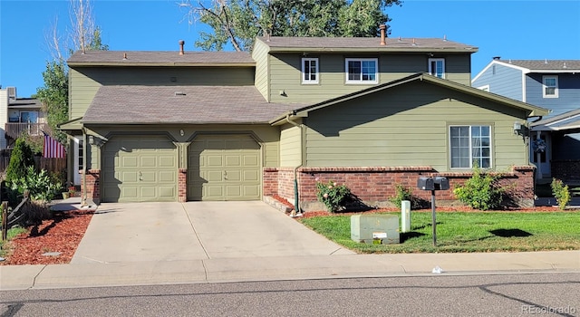 view of front of house with a front lawn and a garage