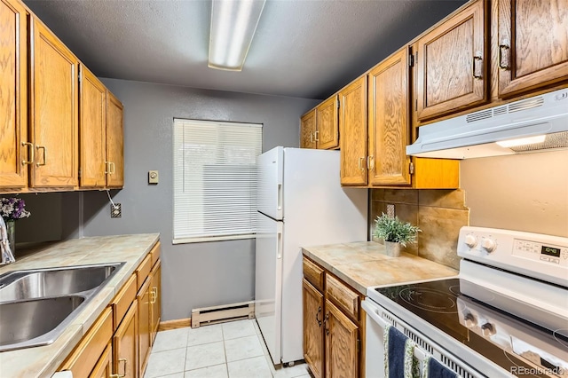 kitchen with white appliances, under cabinet range hood, a sink, baseboard heating, and light countertops